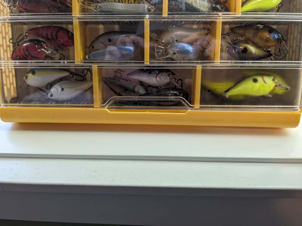 Variety of squarebill crankbaits organized neatly in a Plano Edge tackle box, showcasing a range of colors and sizes for optimal largemouth bass fishing