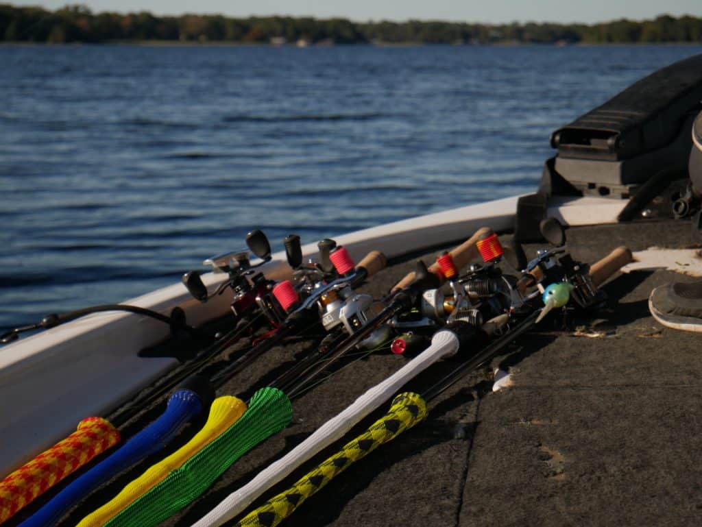 A variety of baitcasting and spinning rods and reels displayed side by side, showcasing differences and similarities for optimal bass fishing gear selection