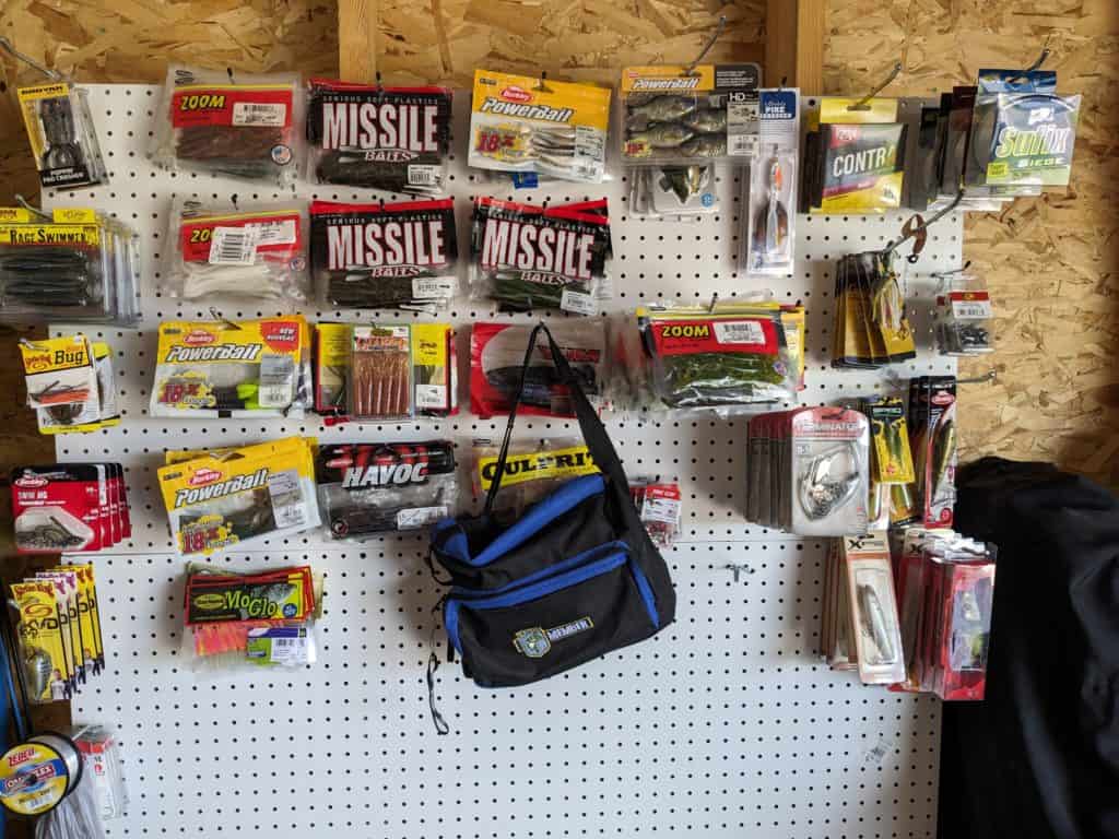 An impressive peg board wall displaying a variety of fishing lures and soft plastics in an organized, easy-to-access arrangement, highlighting efficient tackle storage methods.