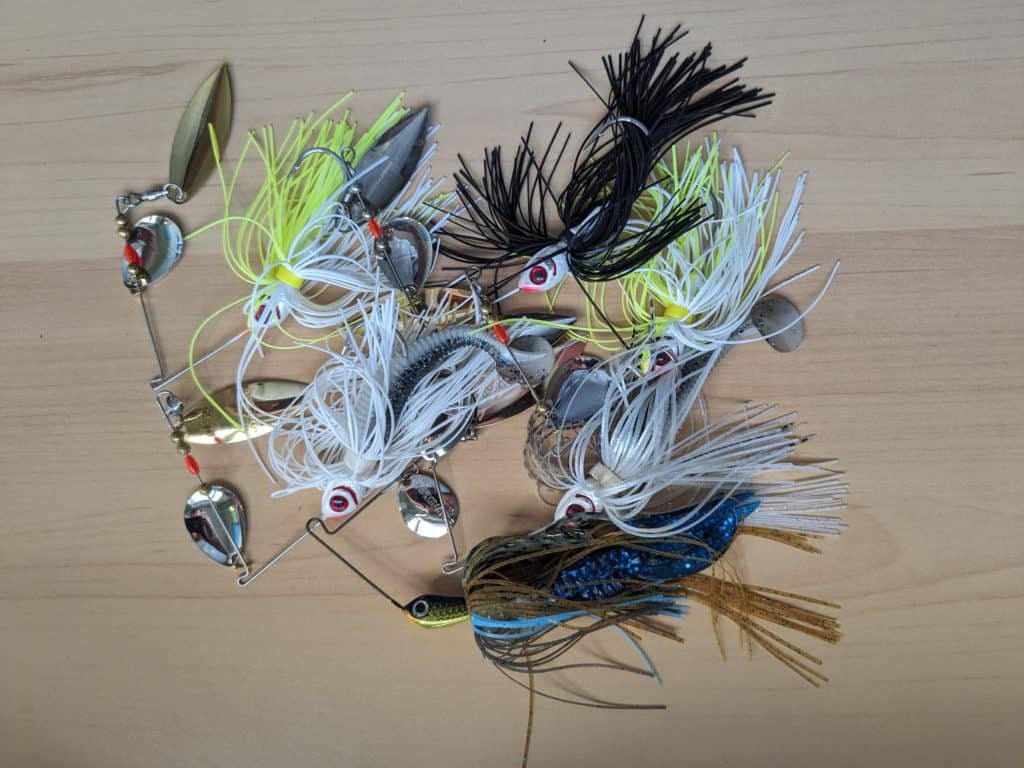 Beginner-friendly collection of various types of spinnerbaits, highlighting diverse shapes, sizes, and colors for learning how to fish a spinnerbait.