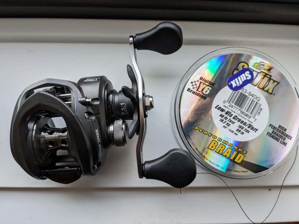 Close-up image of a Lew's Speed Spool reel with Sufix braided line, optimized for frog fishing with the versatile Booyah Pad Crasher.