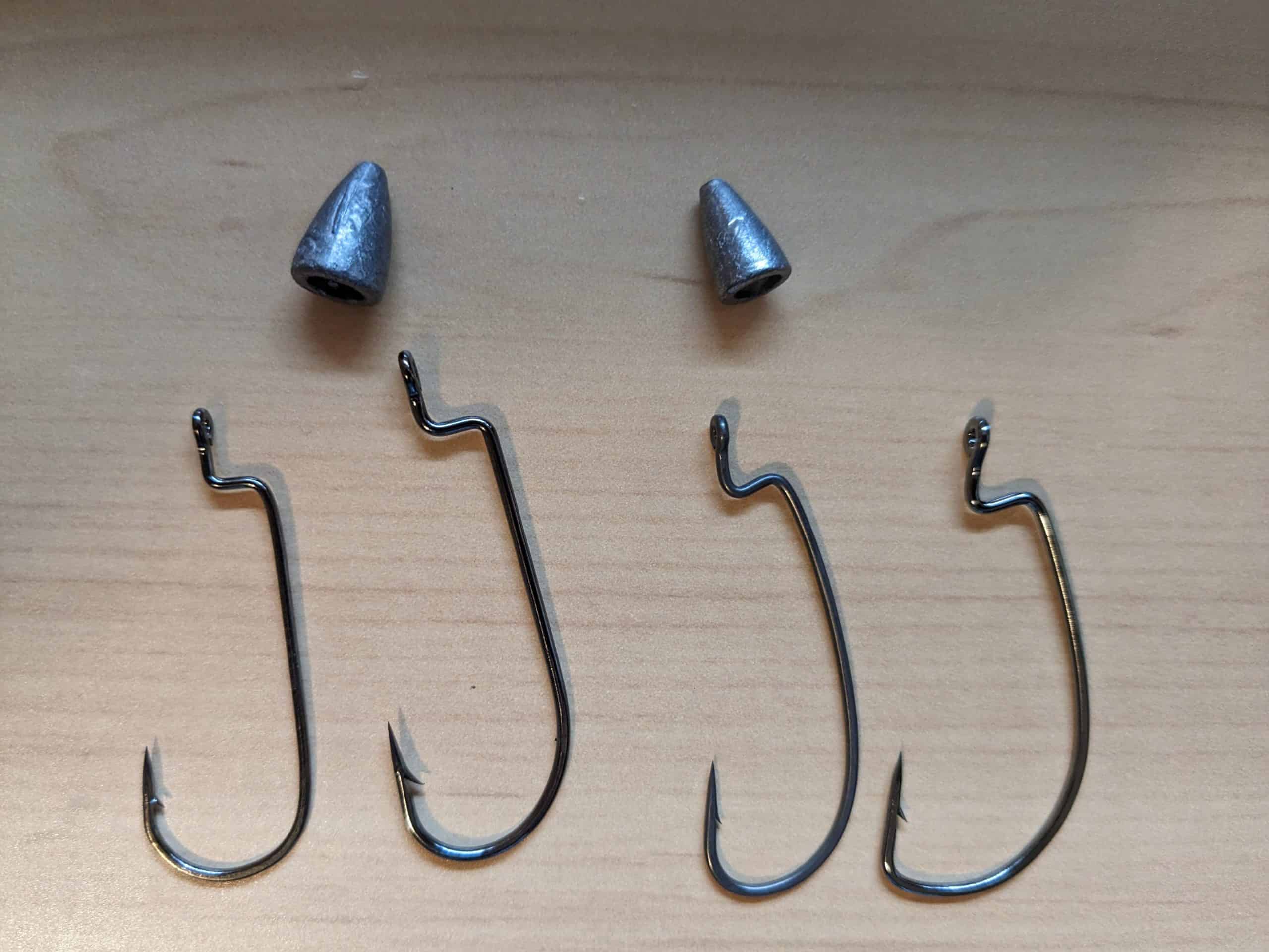 Variety of EWG and Offset Worm Hooks Laid Out for Texas Rigging in Bass Fishing