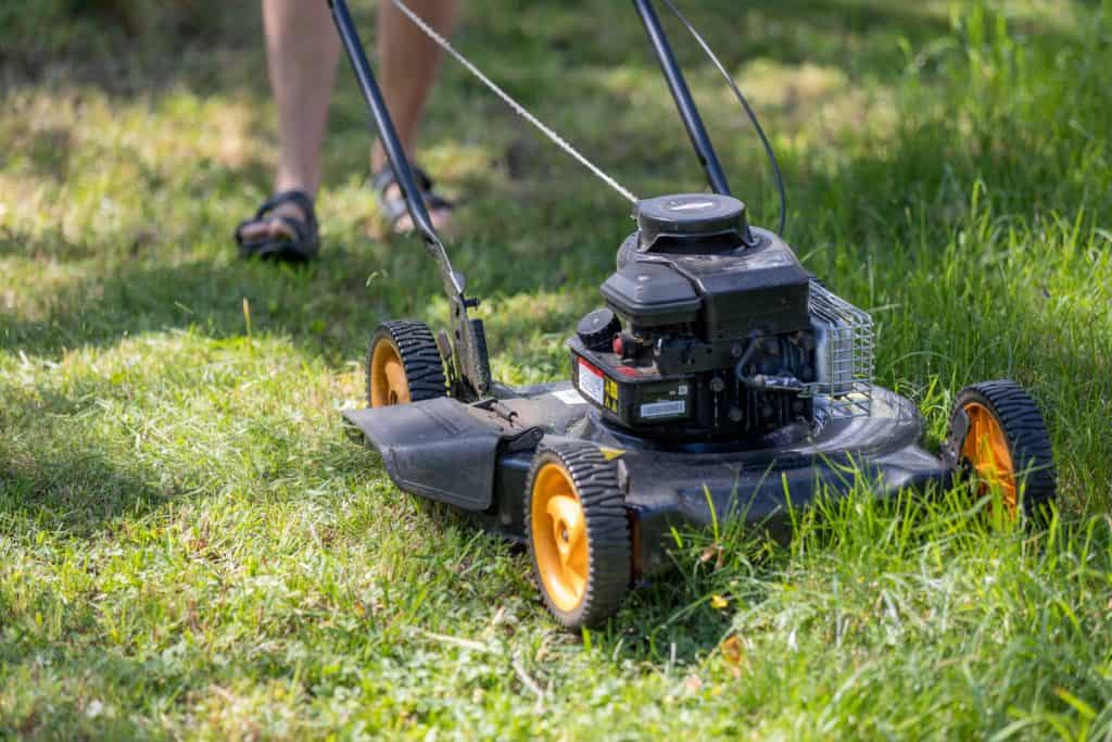 Angler mowing grass around a private pond, demonstrating commitment to its upkeep