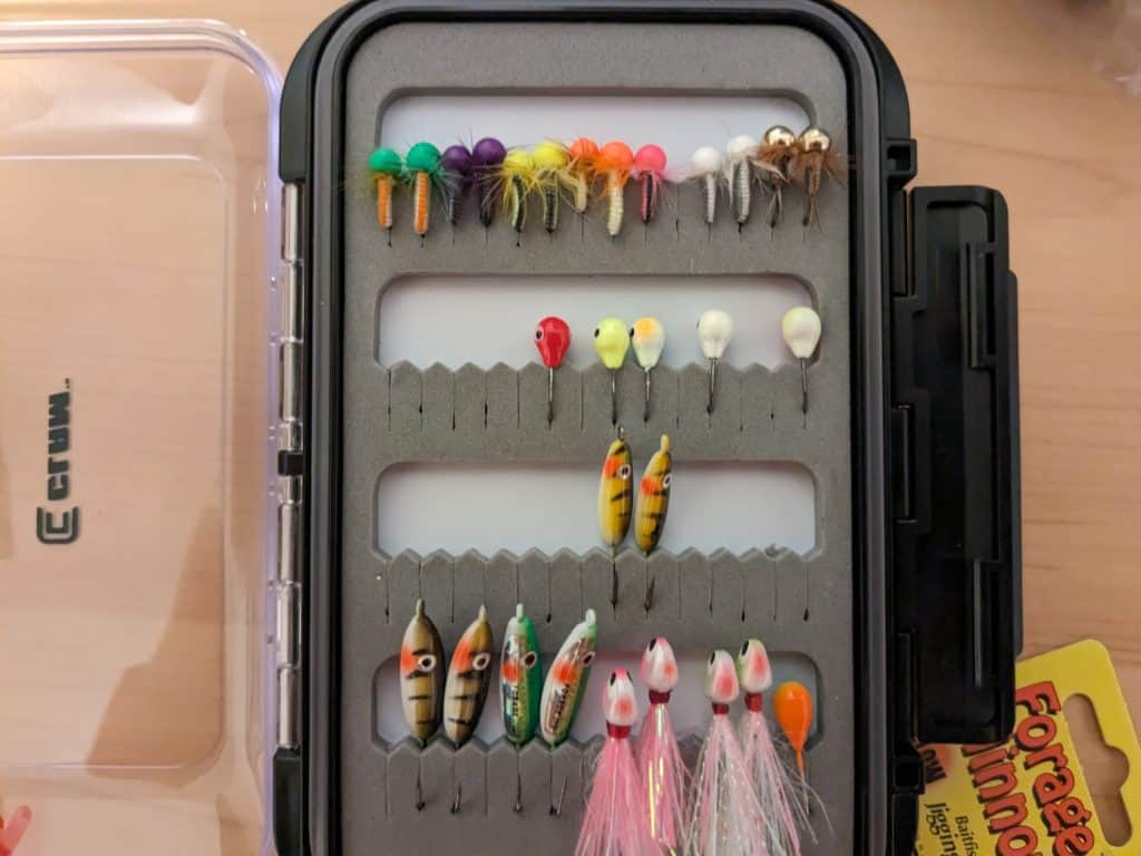 A variety of tungsten and fly jigs used for ice fishing for bass