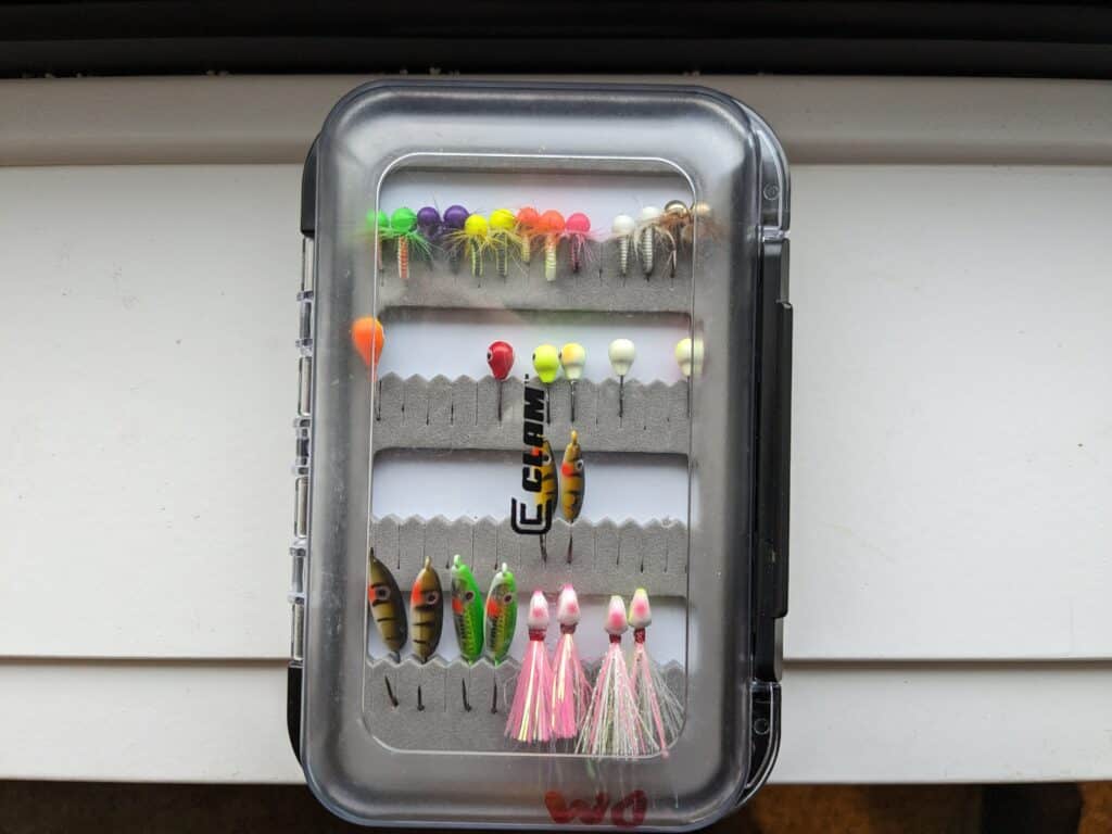 Lures used for ice fishing for bass that include jigs and spoons. 